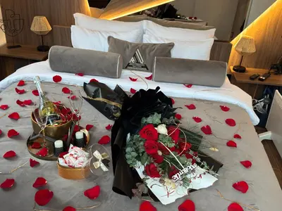 a bed with a bunch of red roses on it at Apartman Riva in Vrnjačka Banja