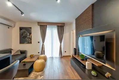 a living room with a large flat screen tv at Apartman Riva in Vrnjačka Banja