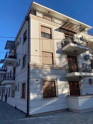 a white building with balconies on the side of it at Apartman Riva in Vrnjačka Banja