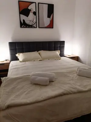 a large bed with two towels on top of it at Apartman Dolce Vita Sokobanja in Soko Banja