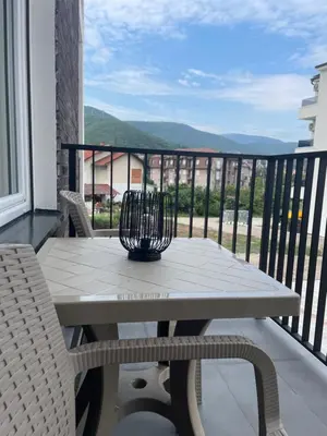 a table and chairs on a balcony with a view at Apartman Dolce Vita Sokobanja in Soko Banja