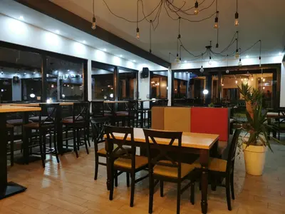 a restaurant with tables and chairs and windows at La Vie En Rose - Milmari Resort in Kopaonik