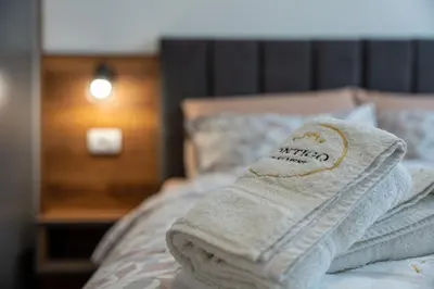 a pair of towels sitting on top of a bed at Contigo Apartman Vrnjacka Banja - Vrnjacka promenada in Vrnjačka Banja