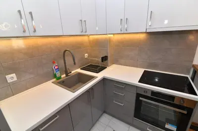 a small kitchen with a sink and a stove at Apartman Dina in Pirot