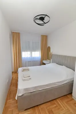 a bedroom with a large bed in a room at Apartman Dina in Pirot