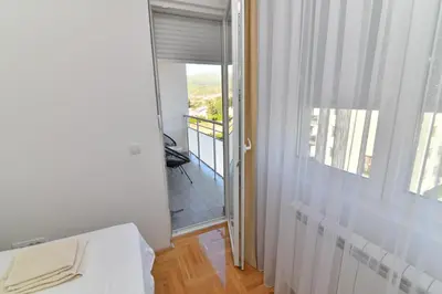 a room with a door leading to a balcony with a view at Apartman Dina in Pirot