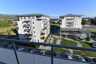 a view of two buildings from a balcony at Apartman Dina in Pirot
