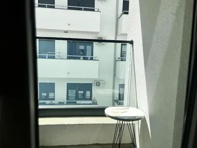 a stool sitting on the balcony of a building at Skandik Luxe Residence in Jagodina
