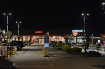 a mall at night with a sign in a parking lot at Skandik Luxe Residence in Jagodina