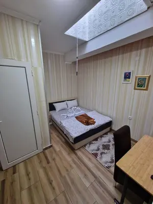 a small room with a bed and a table at Hotel Saradis in Kruševac