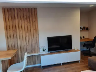 a living room with a television on a white cabinet at Dream Home, FREE GARAGE in Niš