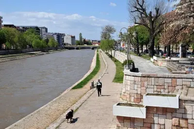 a man and two dogs walking along a river at Dream Home, FREE GARAGE in Niš