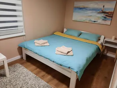 a bedroom with a bed with towels on it at Dream Home, FREE GARAGE in Niš