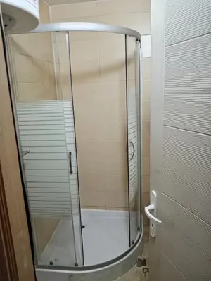 a shower with a glass door in a bathroom at Etno Dušnik in Gadžin Han