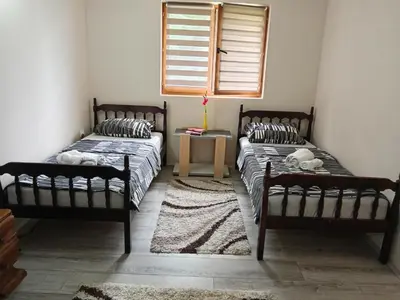 two beds sitting in a room with a window at Etno Dušnik in Gadžin Han