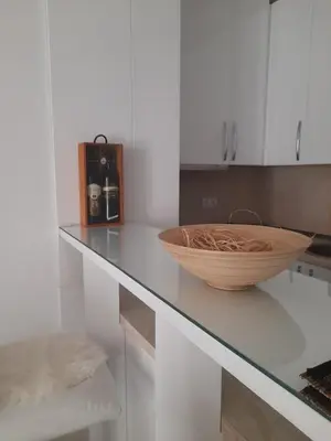 a white kitchen with a bowl on a counter at Apartman Mančić in Pirot