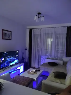 a living room with purple lights in a living room at Apartman Mančić in Pirot