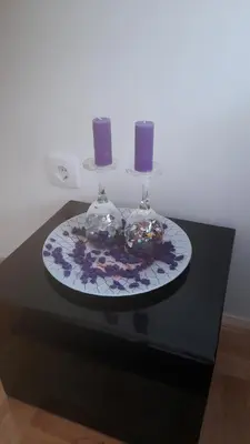 a black table with two wine glasses and two candles at Apartman Mančić in Pirot
