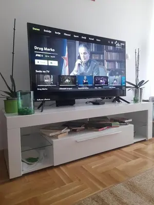 a flat screen tv sitting on a white entertainment center at Apartman Mančić in Pirot