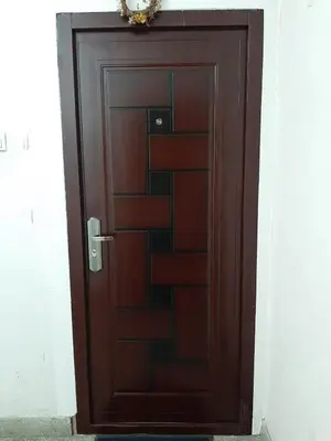 a wooden door with a wreath on top of it at Apartman Sofka in Vranje