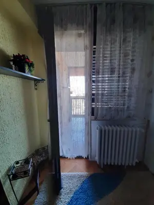 a living room with a window and a radiator at Apartman Sofka in Vranje