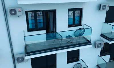 a glass aquarium with two chairs in it at apartman gold Jagodina in Jagodina