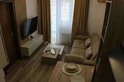 a living room with a couch and a tv at apartman gold Jagodina in Jagodina