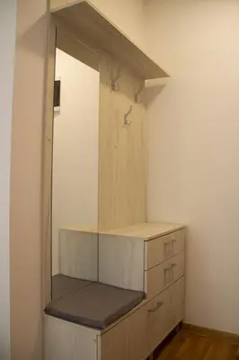 a wooden cabinet with a mirror in a room at Vasilije in Vrnjačka Banja