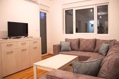 a living room with a couch and a flat screen tv at Vasilije in Vrnjačka Banja