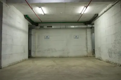 an empty parking garage with two lights on the wall at Vasilije in Vrnjačka Banja