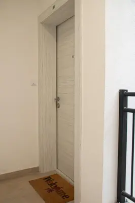 a door in the side of a room with a rug at Vasilije in Vrnjačka Banja