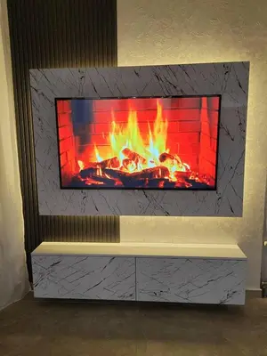 a fireplace with a tv on top of it at Hedonic Wellness Apartmani in Niš