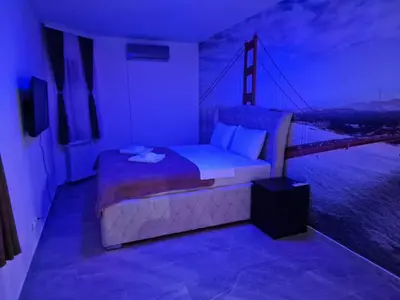 a bedroom with a bed with a view of a bridge at Hedonic Wellness Apartmani in Niš