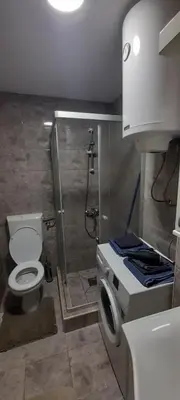 a bathroom with a shower and a toilet and a sink at Apartman Vanja in Paraćin