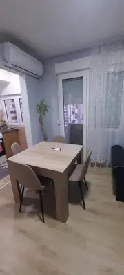 a dining room with a table and chairs in a room at Apartman Vanja in Paraćin