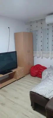 a living room with a flat screen tv and a couch at Apartman Vanja in Paraćin