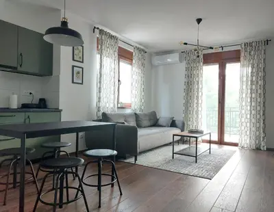 a living room with a couch and a table at Tilia Home in Vrnjačka Banja