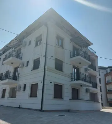 a white building with balconies on the side of it at Tilia Home in Vrnjačka Banja