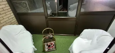 a purse sitting on the floor next to two beds at AIK Kula studio in Jagodina