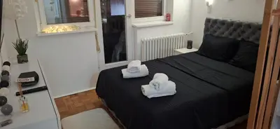 a bedroom with two towels on a bed at AIK Kula studio in Jagodina