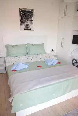 a bedroom with a large bed with towels on it at Apartman Ruby in Vrnjačka Banja