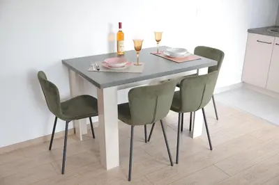 a dining room table with four chairs and a bottle of wine at Apartman Ruby in Vrnjačka Banja