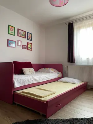 two twin beds in a room with a window at IKONIJA guest house in Pečenjevce