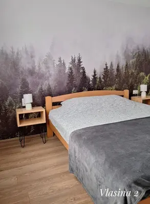 a bedroom with a mural of a pine forest at Apartmani Vlasina Sokobanja in Soko Banja