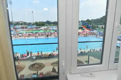 a view of a swimming pool from a window at Aljoša Luxury Apartment in Jagodina