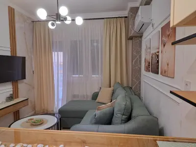 a small living room with a couch and a tv at Aljoša Luxury Apartment in Jagodina