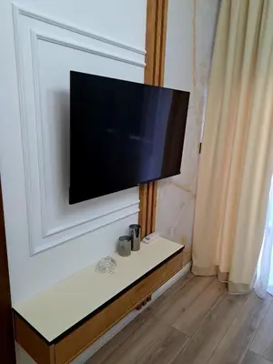 a flat screen tv hanging on a wall at Aljoša Luxury Apartment in Jagodina