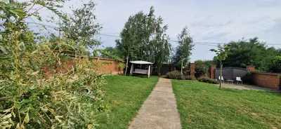 a garden with a pathway and a gazebo at Vila Elena in Niš