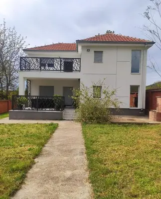 a white house with a pathway in front of it at Vila Elena in Niš
