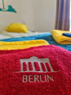 a red rug with the word berlin on it at Apartman Berlin Sokobanja in Soko Banja